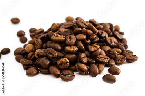 Pile of roasted coffee beans isolated on white background.
