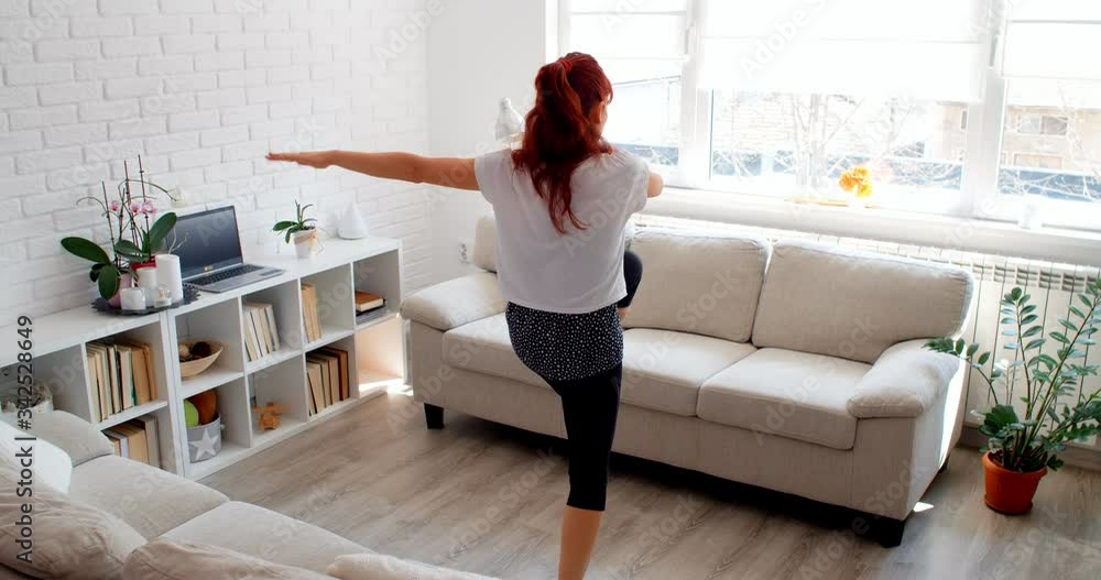 COVID-19 concept. A woman doing sports at home isolated alone during a quarantine. 4k COVID-19 concept. A woman doing sports at home isolated alone during a quarantine. 4k
