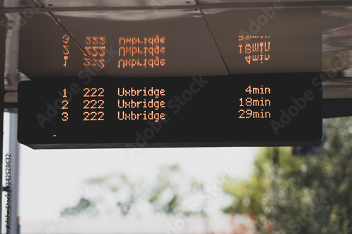 Close-up of an electronic sign of a bus stop in public transport in Uxbridge, London, UK