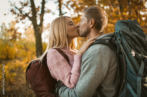 Kiss Of Young Couple In Autumn Forest