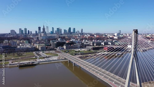 Panoramic view from drone of Warsaw modern cityscape on left bank of Vistula river with cable-stayed Swietokrzyski bridge in spring, Poland photo