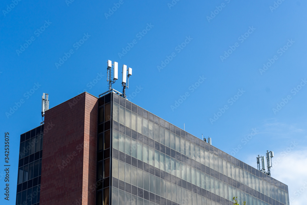 Obraz premium A modern office block with 5G antennas on top of it