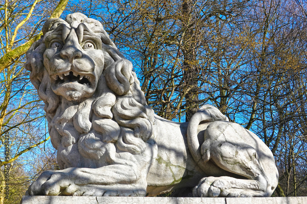 Terrified looking lion, sculpture by Joseph Dubois, 1780, at the gate of the Brussels Park (Parc de Bruxelles), opposite of the Royal Palace, Brussels, Belgium