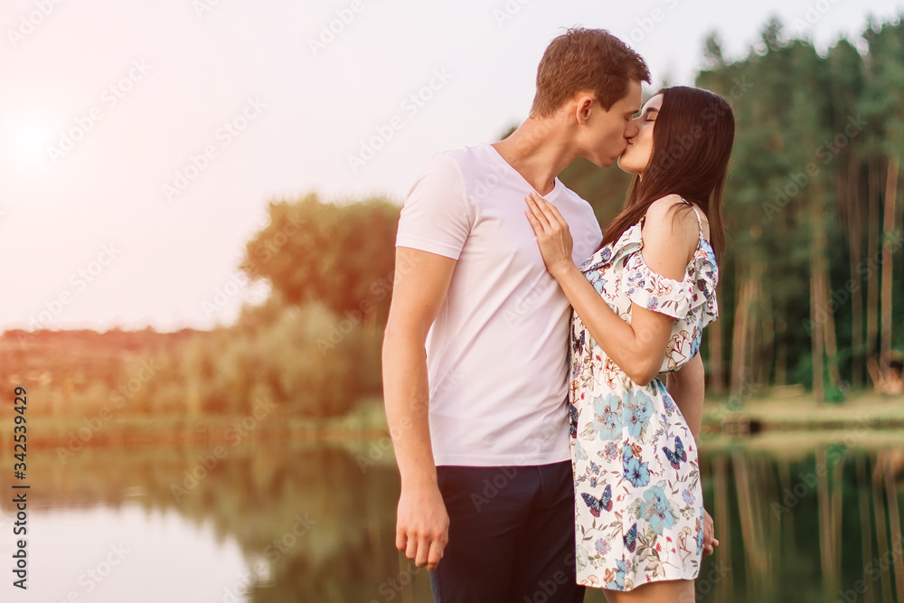 Young loving couple hugging and walking near lake. Young loving couple hugging and walking near lake.