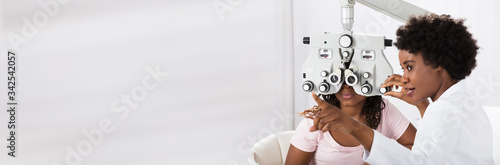 Optometrist Doing Sight Testing For Patient photo