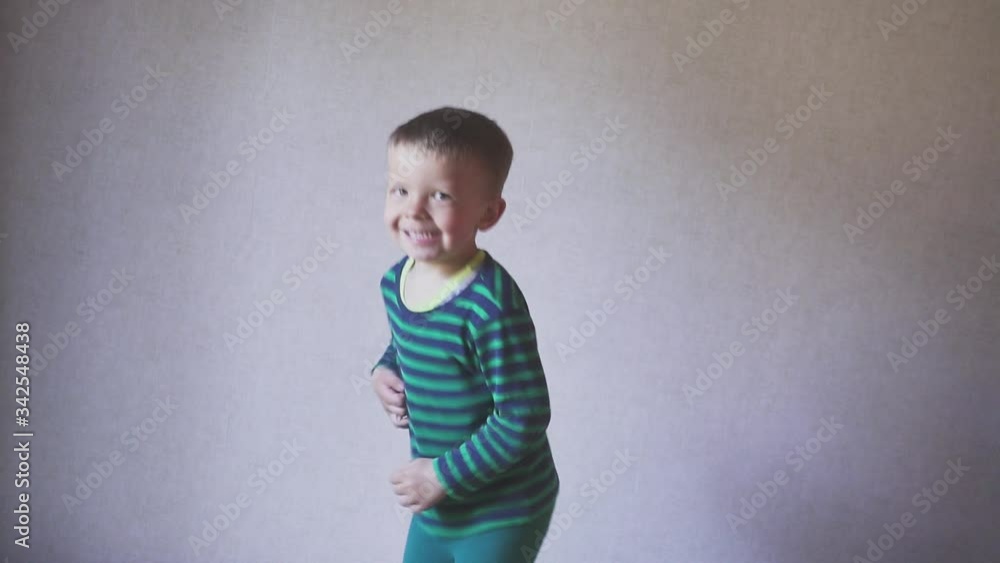 Happy fany boy child jumping on bed in bedroom. Childhood concept. skow motion. Happy fany boy child jumping on bed in bedroom. Childhood concept. skow motion.