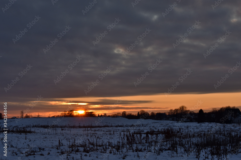 colorful sunset over a snow-covered field