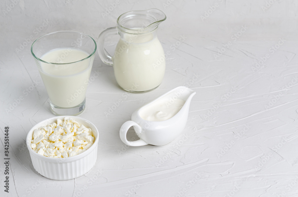 Homemade fermented drink in a glass of kefir, cottage cheese, sour cream on a white background, copy space. Homemade fermented drink in a glass of kefir, cottage cheese, sour cream on a white background, copy space.