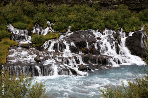 Hraunfossar   Iceland - August 15  2017  Hraunfossar waterfalls formed by rivulets streaming out of the Hallmundarhraun lava field formed by the eruption of a volcano lying under the glacier Langjokul