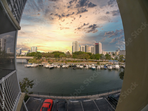 Looking at a sunset through a fisheye lens between buildings