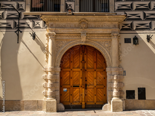 Almost empty medieval Kanonicza street in Krakow during coronavirus covid-19 pandemic. Beautiful medieval decorative gate. photo