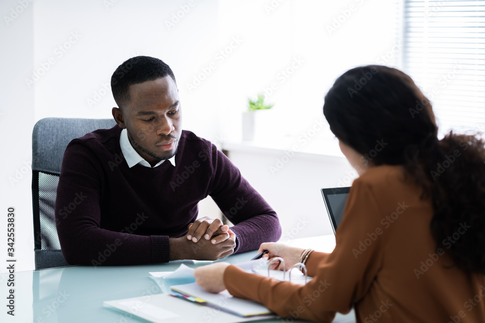 Financial Advisor Discussing Invoice With Her Client Financial Advisor Discussing Invoice With Her Client