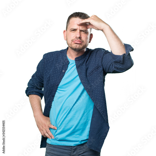 Young man wearing a blue outfit. Looking tired.
