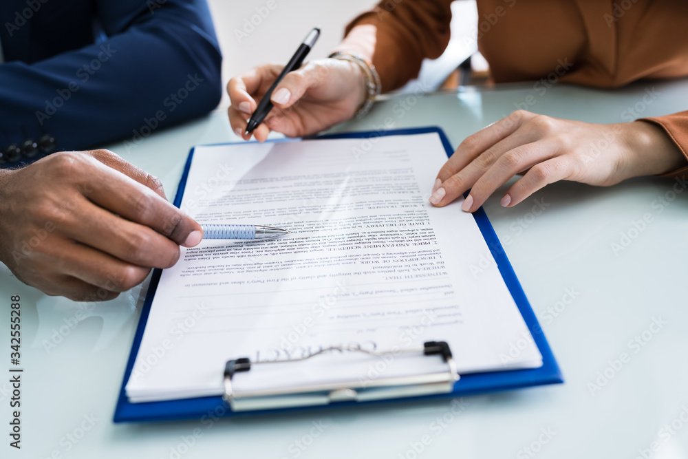 Two Businesspeople Analyzing Document Two Businesspeople Analyzing Document