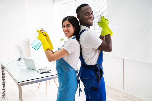 Two Janitors Standing Back To Back