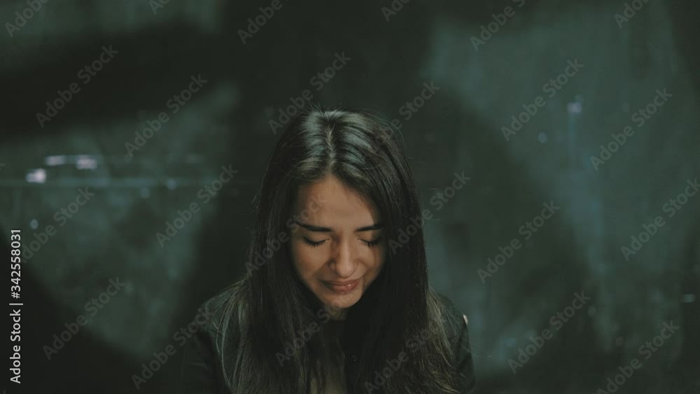 A young sadly woman ,Domestic Violence,looking at camera and crying,Sitting in a dark interrogation room,clouse up, A young sadly woman ,Domestic Violence,looking at camera and crying,Sitting in a dark interrogation room,clouse up,