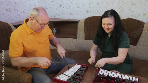 Husband and wife play metalphones at home. photo