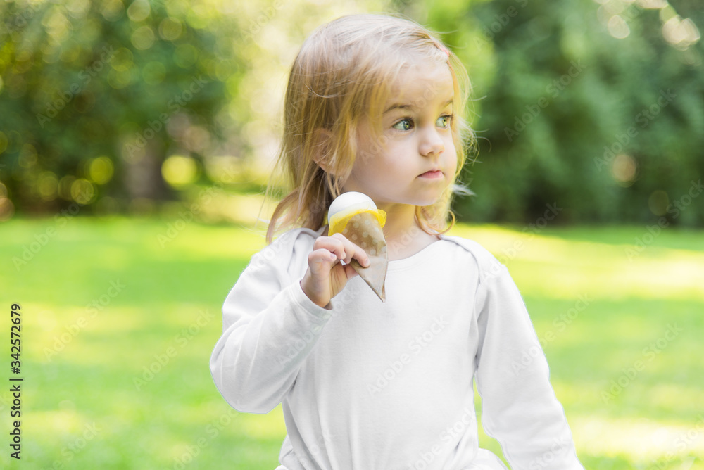 A little beautiful girl walks in the park with a picnic basket and straw hat. Funny emotional baby. A little beautiful girl walks in the park with a picnic basket and straw hat. Funny emotional baby.