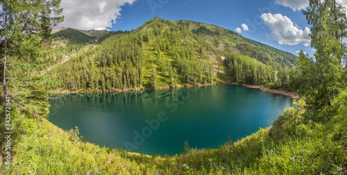 Picturesque forest lake, summer mountain landscape. Wild lake in Siberia, travel and leisure