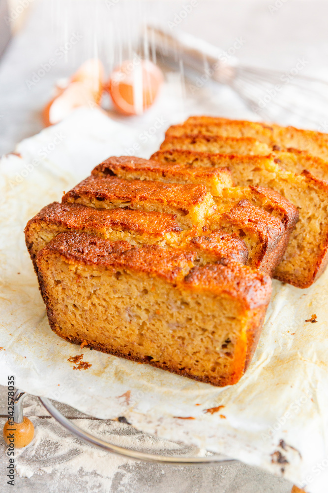 Banana Bread with Ingredients on Grey Background