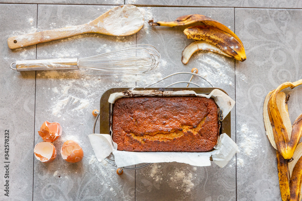 Banana Bread with Ingredients on Grey Background