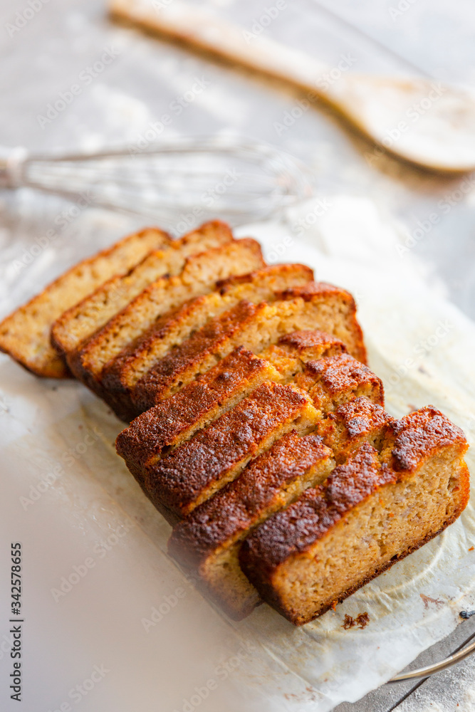Banana Bread with Ingredients on Grey Background