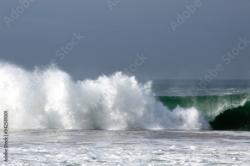 Sea waves crashing against clear sky