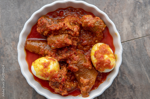 African national food dish grilled meat and chicken dish wings home-made Cuisine with plantain with jollof rice. Nigerian Jolofrice. Grilled African fish dish and meal with chilli banana and plantain. photo