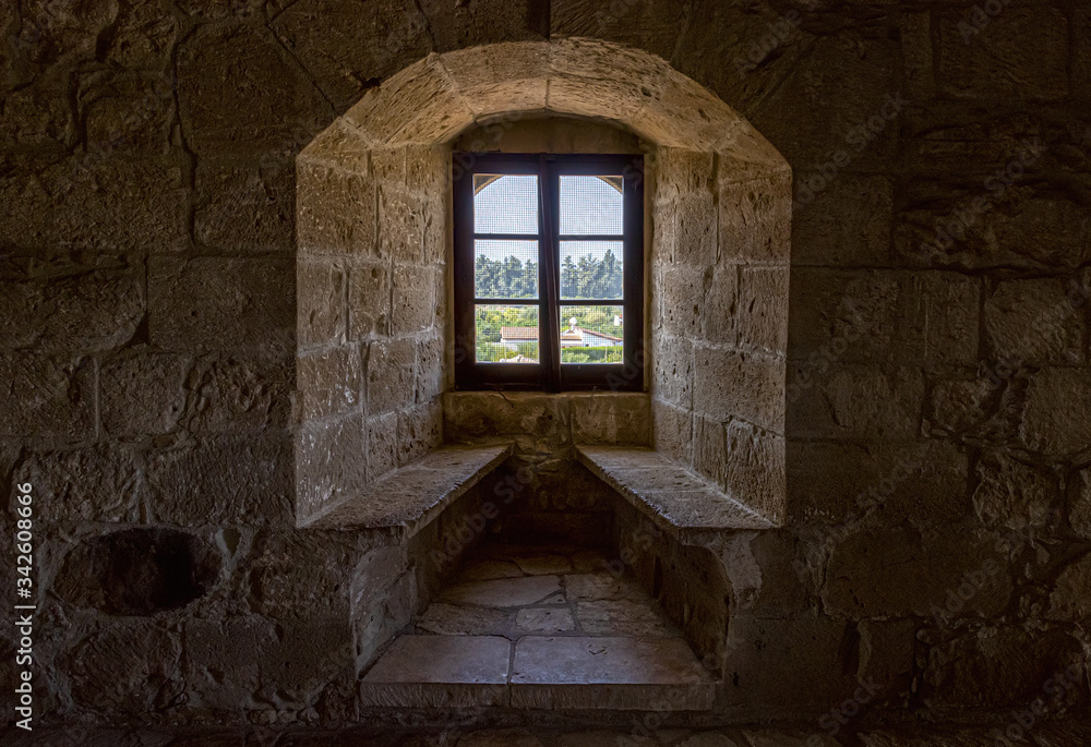 The interior of the medieval Kolossi castle with a window and stone benches (Cyprus).
