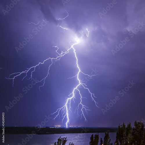 Bright flash of lightning in a stormy night sky