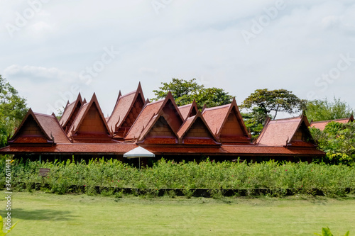 Big and beautiful old Thai style house' roof structure with the green yard of Sampran riverside hoter. Nakornpathom, Thailand September 30, 2017