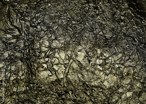 Bronze wrinkled paper texture abstract background. Antique dark golden jammed foil texture, handmade crumpled texture.
