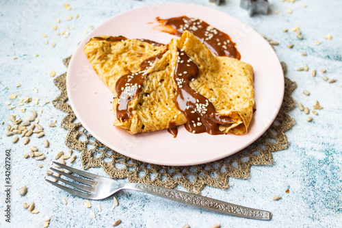 Folded crepes thin pancakes with chocolate sweet spread syrup.