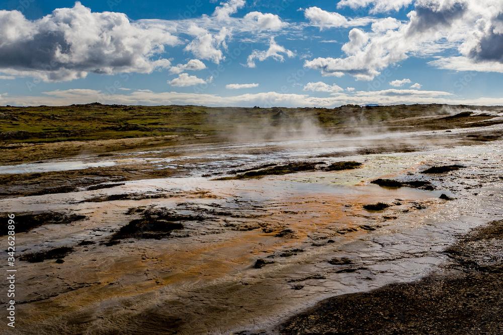 Beautiful colourful Icelandic landscape lava fields mountain geysers zigzag road and moss-covered stones Namafjall, Iceland.