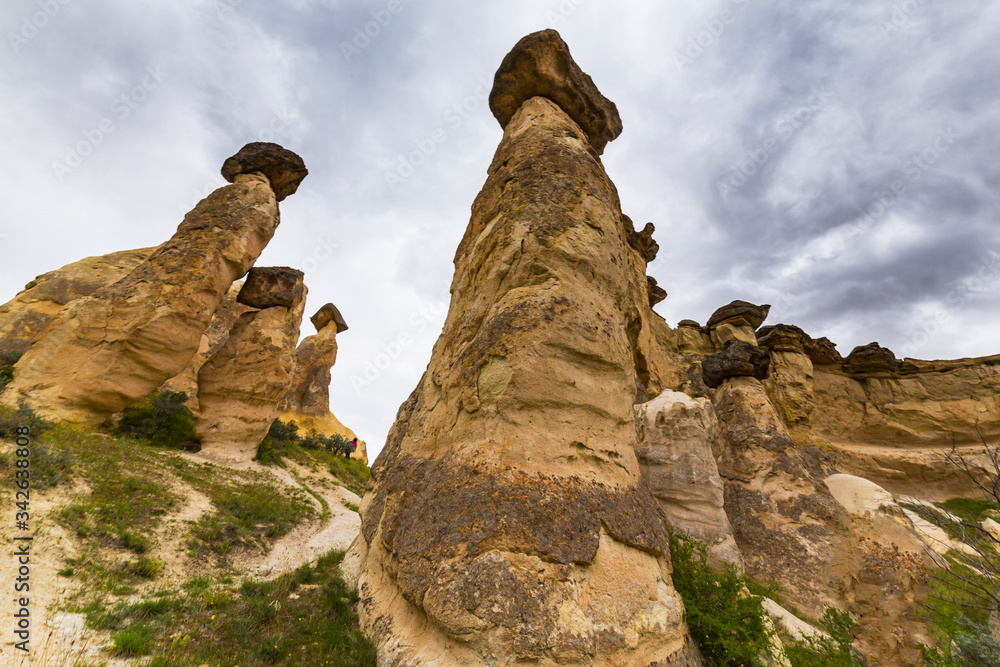 Beautiful sandstone rock formations in Cappadocia, Turkey, under stormy, cloudy, sky Beautiful sandstone rock formations in Cappadocia, Turkey, under stormy, cloudy, sky