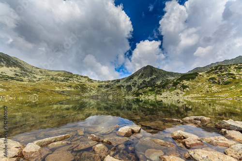 Fototapeta Naklejka Na Ścianę i Meble -  Summer scenery and glacier landscape in the Alps, with beautiful cumulus clouds
