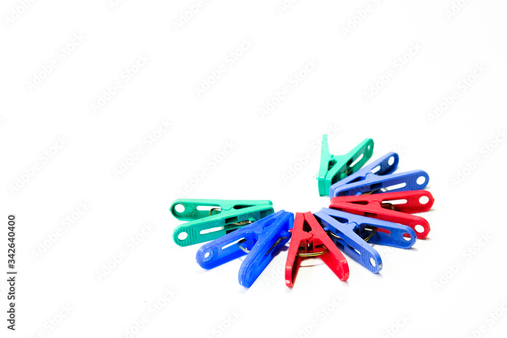 Many different colored plastic clothes pegs isolated on white background. Many different colored plastic clothes pegs isolated on white background.