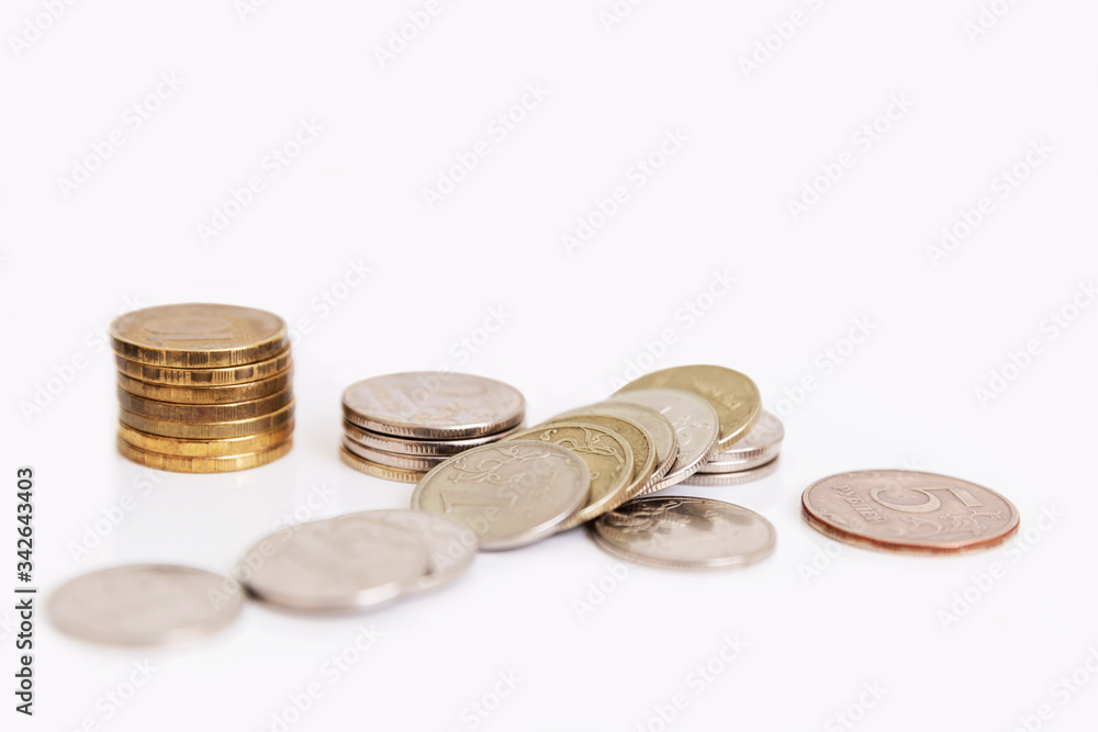 Scattered Russian coins on a white background. Unemployment and poverty amid the coronavirus pandemic. World financial crisis. Scattered Russian coins on a white background. Unemployment and poverty amid the coronavirus pandemic. World financial crisis.