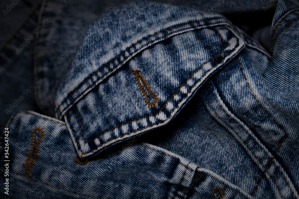 A close-up trend denim jeans jacket pocket