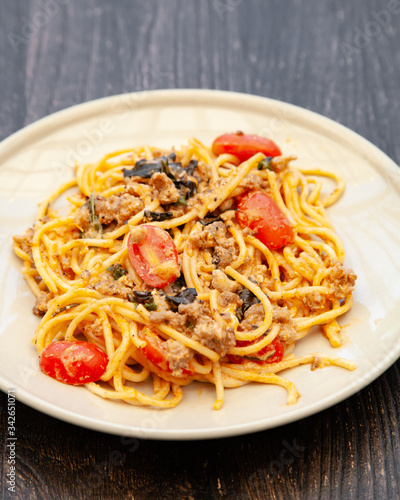Spaghetti bolognese with tomato, cheese and basil on a plate