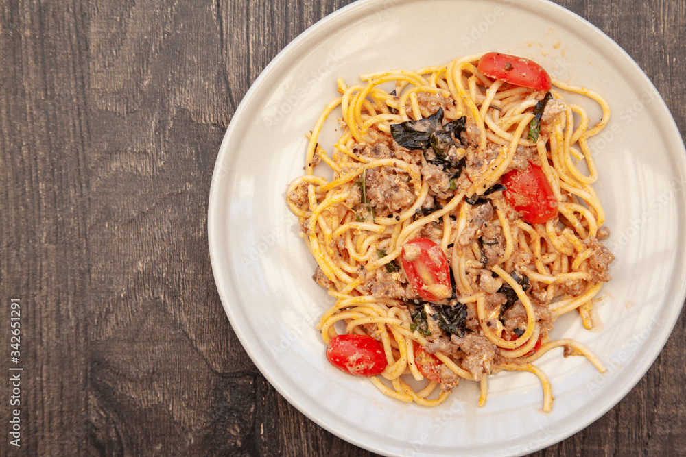 Spaghetti bolognese with tomato, cheese and basil on a plate Spaghetti bolognese with tomato, cheese and basil on a plate