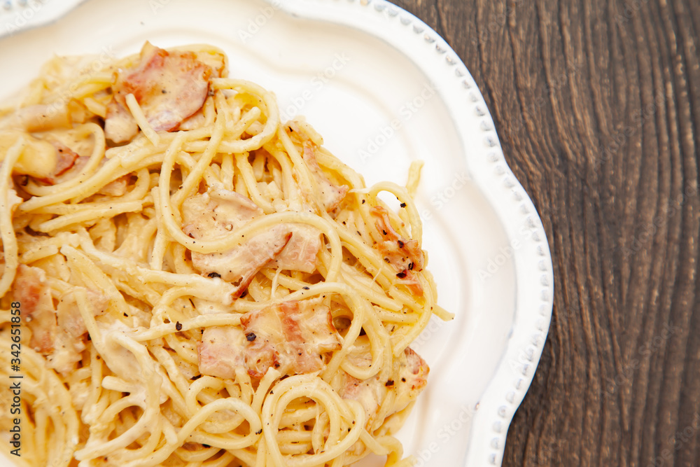 Carbonara pasta, spaghetti with pancetta, egg, hard parmesan cheese and cream sauce. Traditional italian cuisine