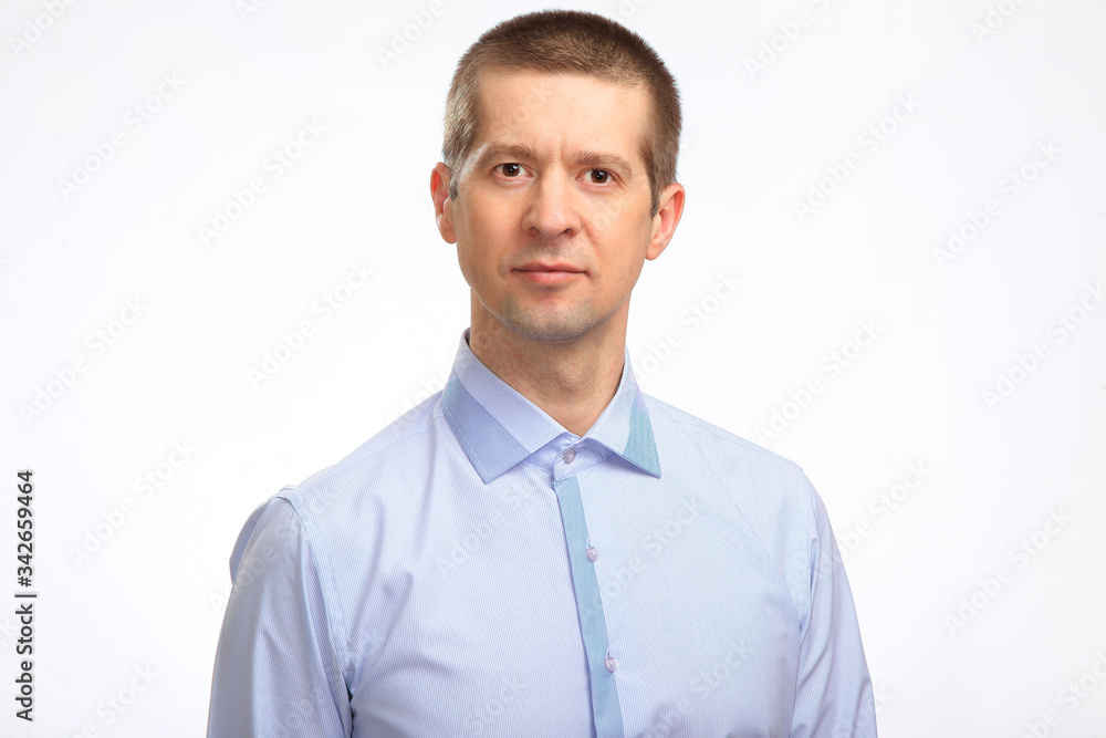 a smiling man in a light shirt looks at the camera. Isolated a smiling man in a light shirt looks at the camera. Isolated