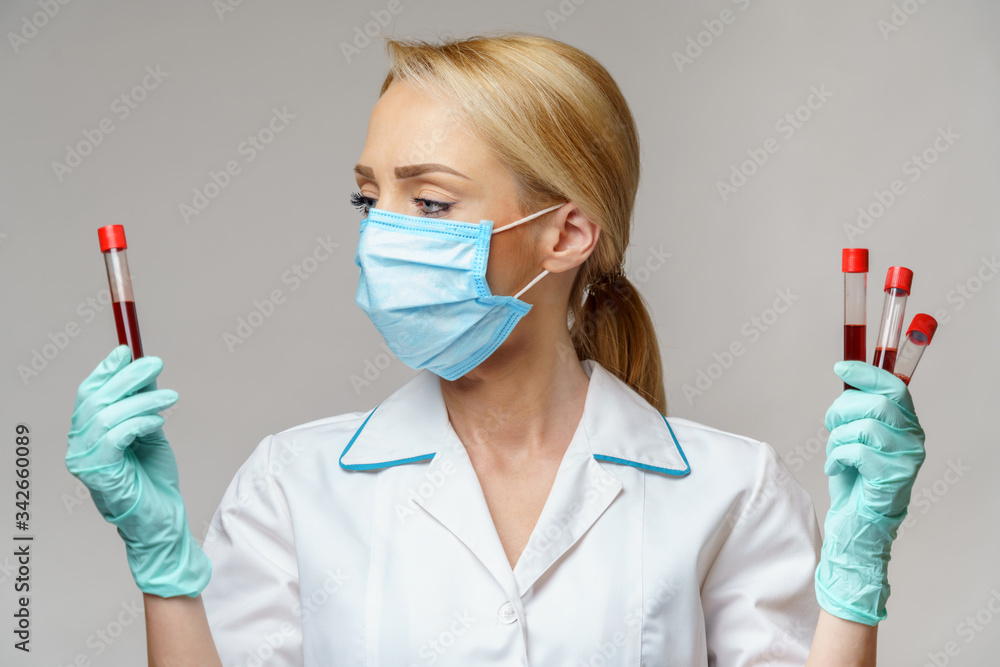 medical doctor nurse woman wearing protective mask and gloves - holding virus blood test medical doctor nurse woman wearing protective mask and gloves - holding virus blood test