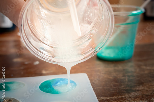 Pouring white glitter resin into mold , process of prepare for make an accessories