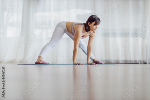Attractive fit yogi woman in Wide Legged Forward Bend. © dusanpetkovic1