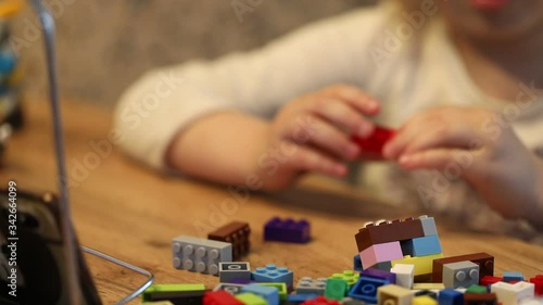 Covid-19 Coronavirus and Learning from home. Little girl online learning and creating at home. Quarantine and Social distancing concept.