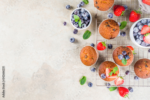 Vanilla muffins or cupcakes with berries