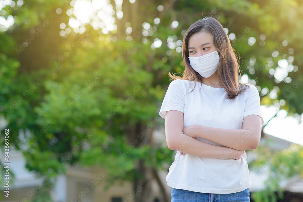 Masked woman - protection against influenza virus. Asia woman wearing mask for protect. Woman wear with protective face mask at home. Stop the virus and epidemic diseases. Masked woman - protection against influenza virus. Asia woman wearing mask for protect. Woman wear with protective face mask at home. Stop the virus and epidemic diseases.