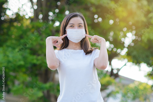 Masked woman - protection against influenza virus. Asia woman wearing mask for protect. Woman wear with protective face mask at home. Stop the virus and epidemic diseases.